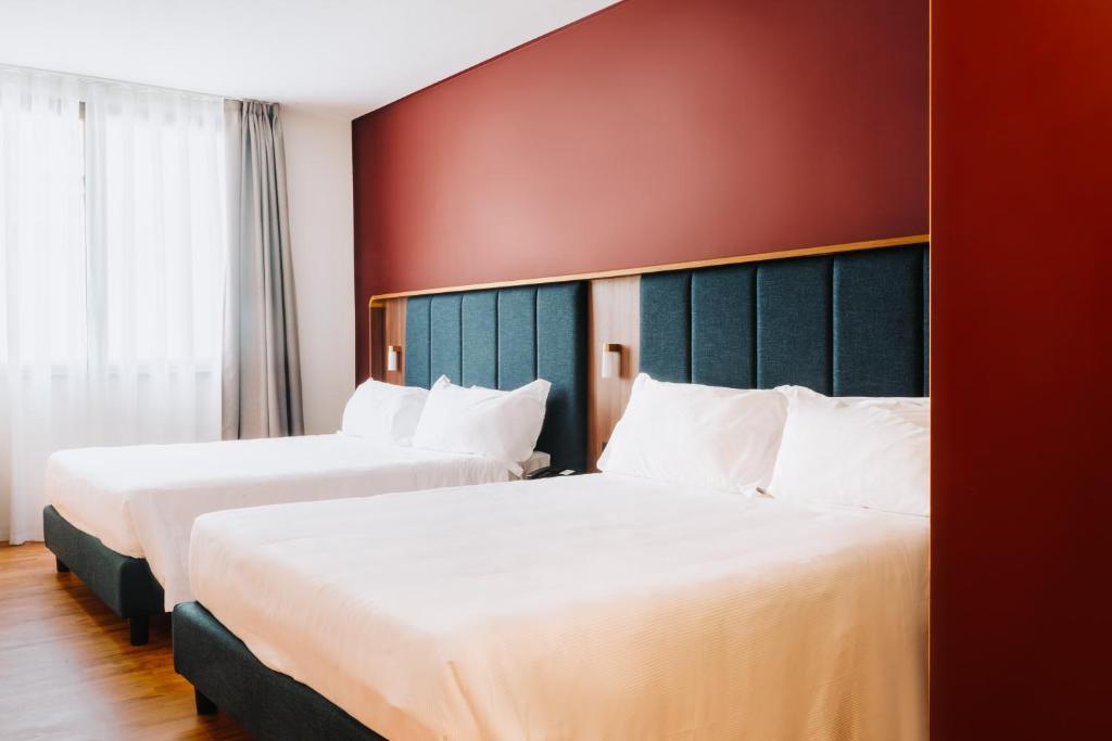 Postel nebo postele na pokoji v ubytování Hotel Ferrara