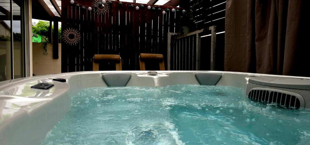 a jacuzzi tub with blue water in it at Chez Marilou in La Plaine des Palmistes