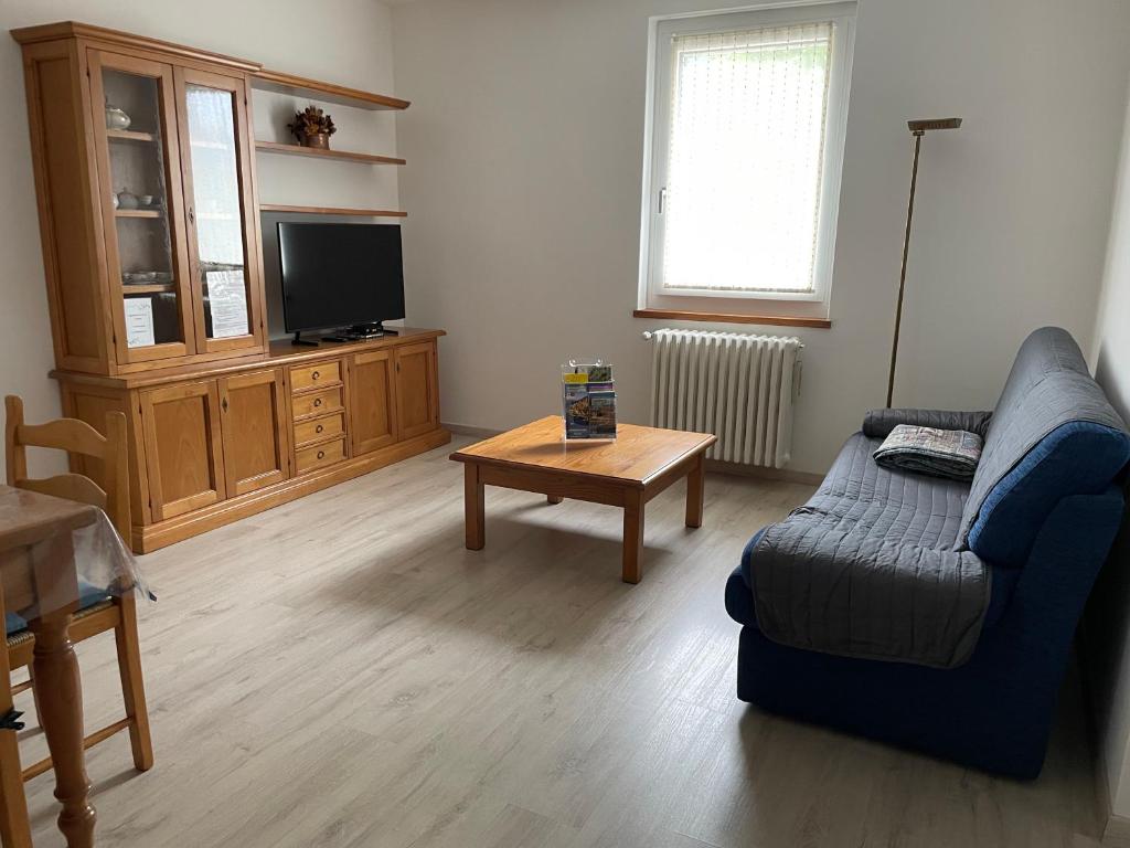 a living room with a couch and a coffee table at Casa Silvia in Morbegno