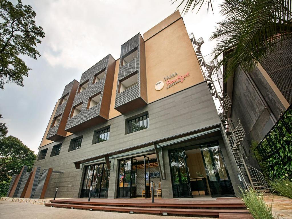 a building with a sign on the front of it at Tama Boutique Hotel in Bandung