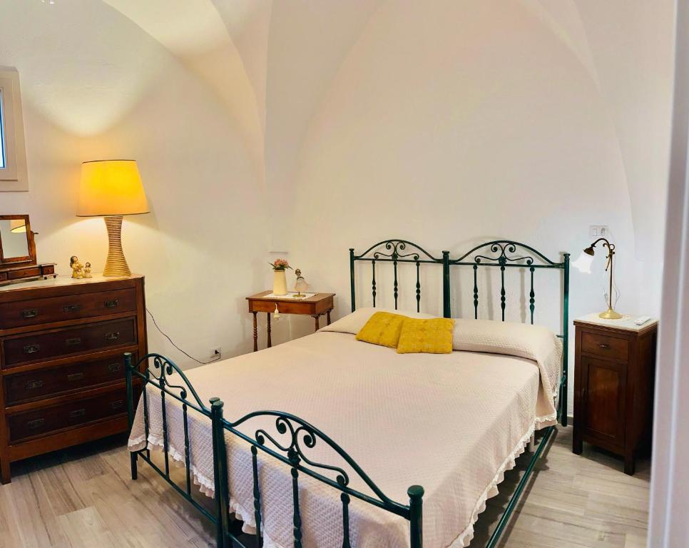 a bedroom with a bed with yellow pillows on it at Casa Vacanze Raimonda in Nardò