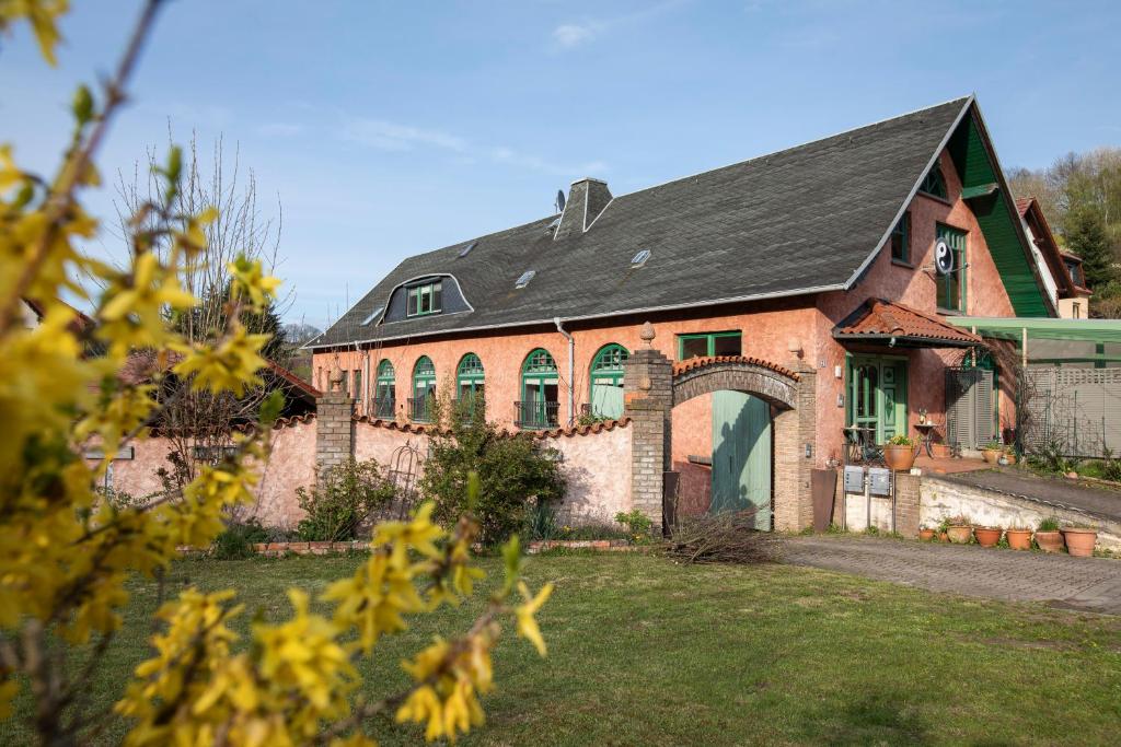 a brick house with a black roof at Ferienwohnung am Sonnenstein in Brehme