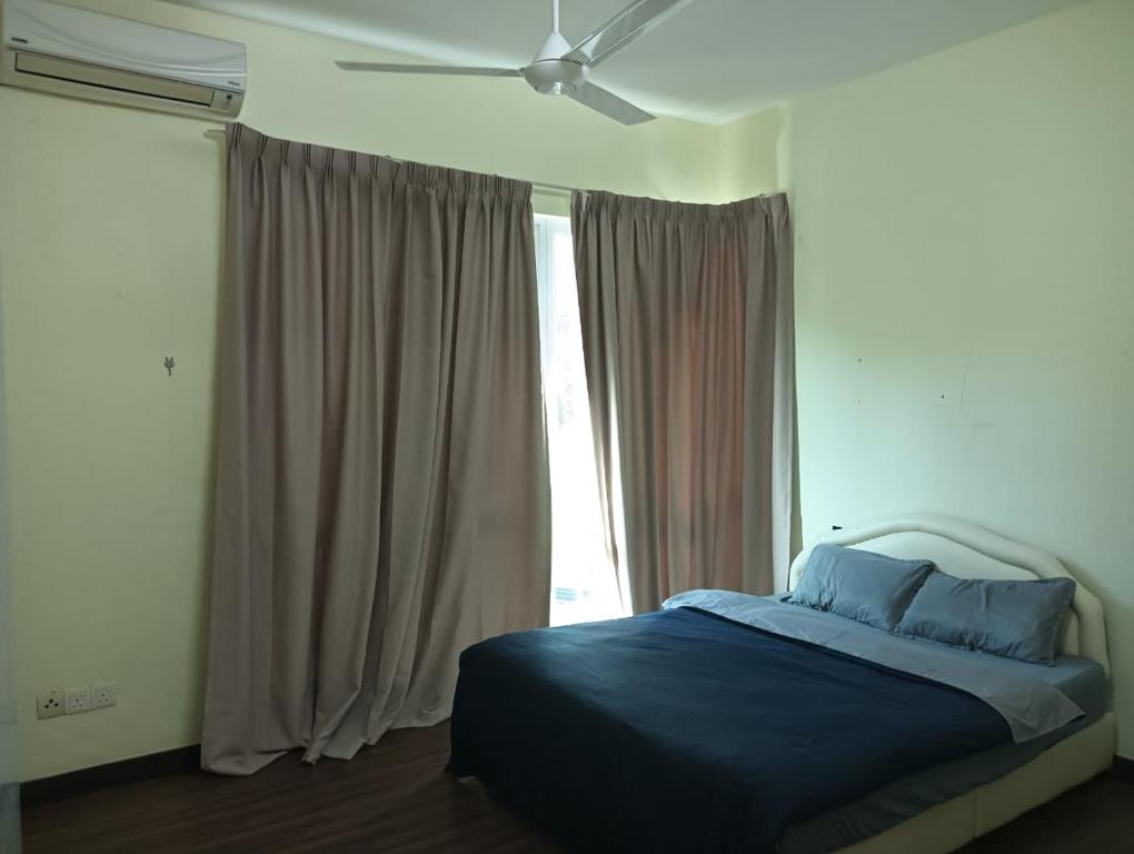 a bedroom with a bed and a ceiling fan at IJM Sri Utama Condo in Sandakan