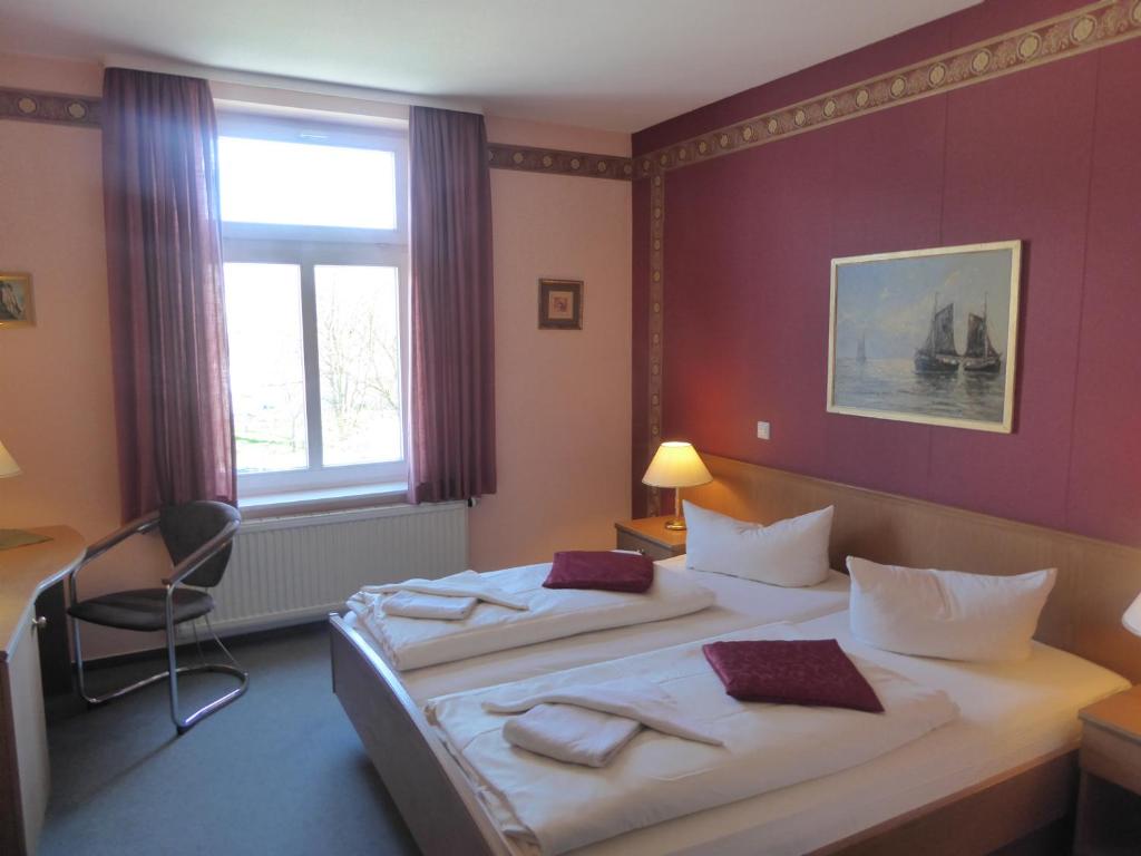 Postel nebo postele na pokoji v ubytování Hotel Koos