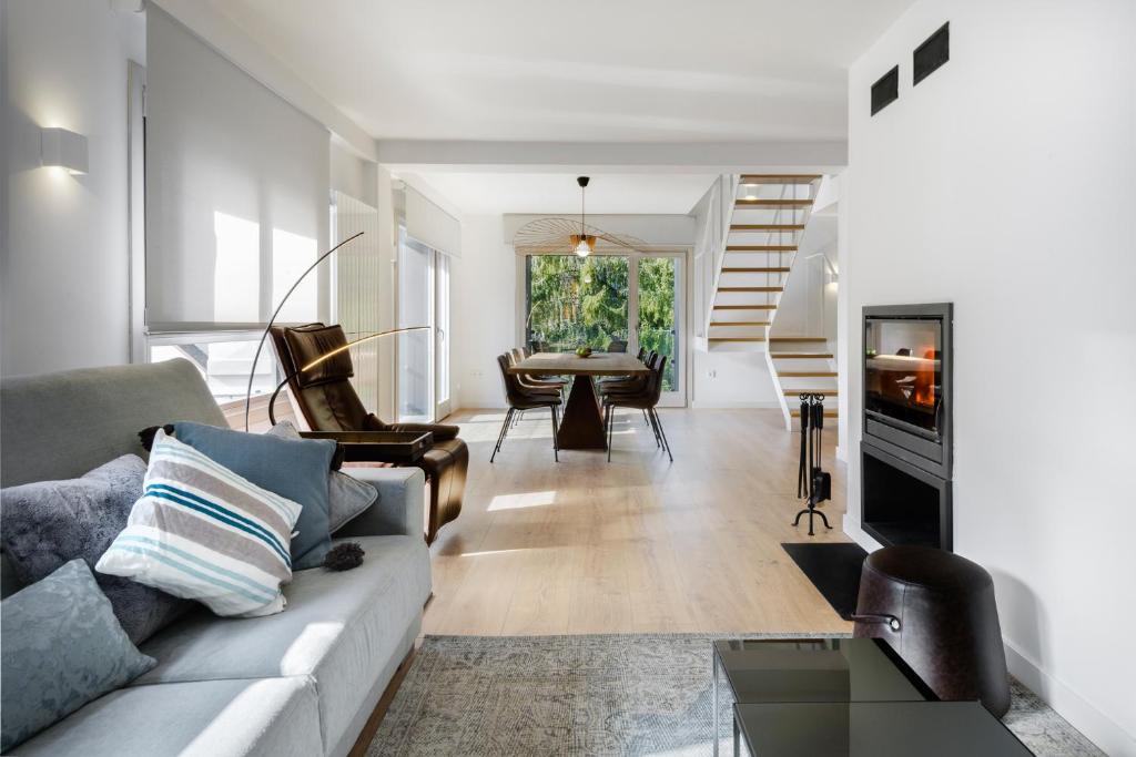 a living room with a couch and a table at Casa Estrimal, Panticosa, grandes familias y pequeños grupos in Panticosa
