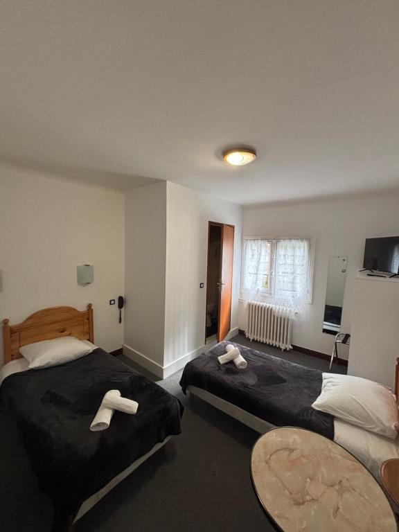 Postel nebo postele na pokoji v ubytování Hotel le Taillon