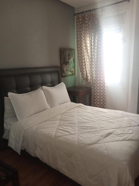 Ένα ή περισσότερα κρεβάτια σε δωμάτιο στο Hotel Astoria Tanger