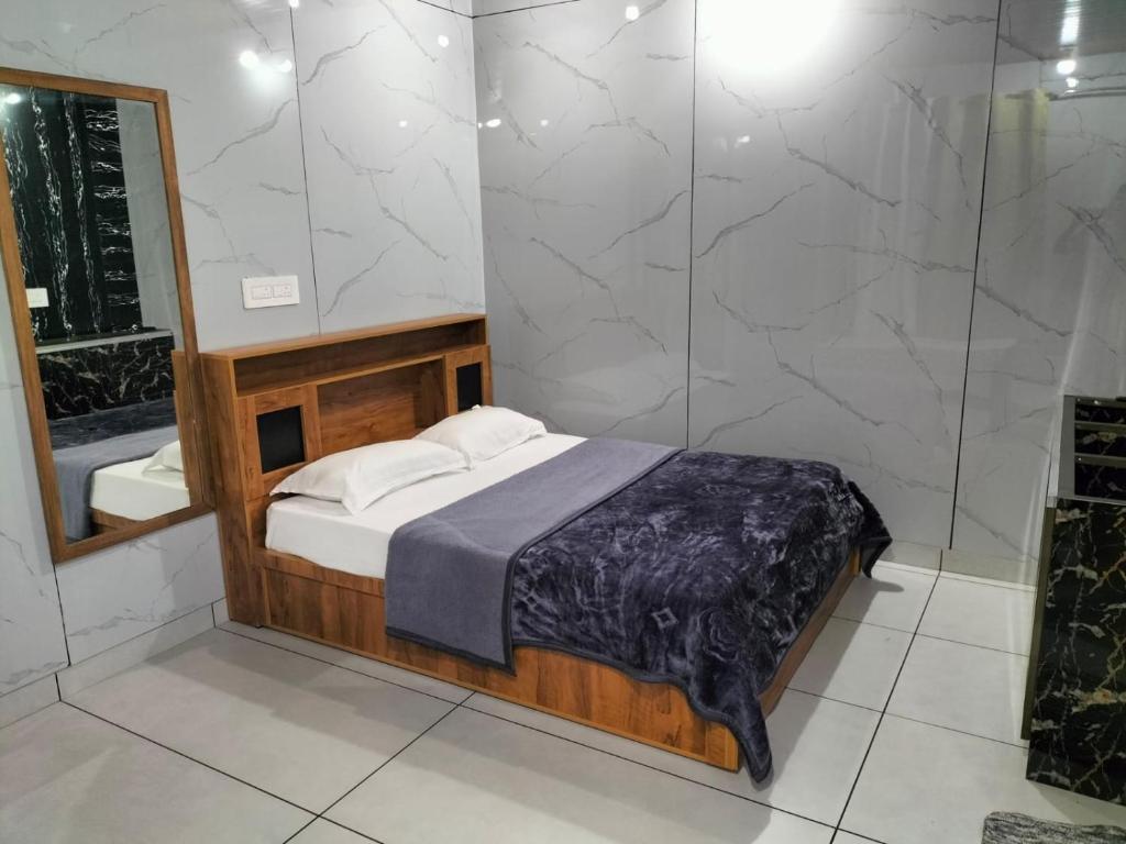 a bedroom with a bed and a mirror and a shower at Diyara's Inn in Madikeri