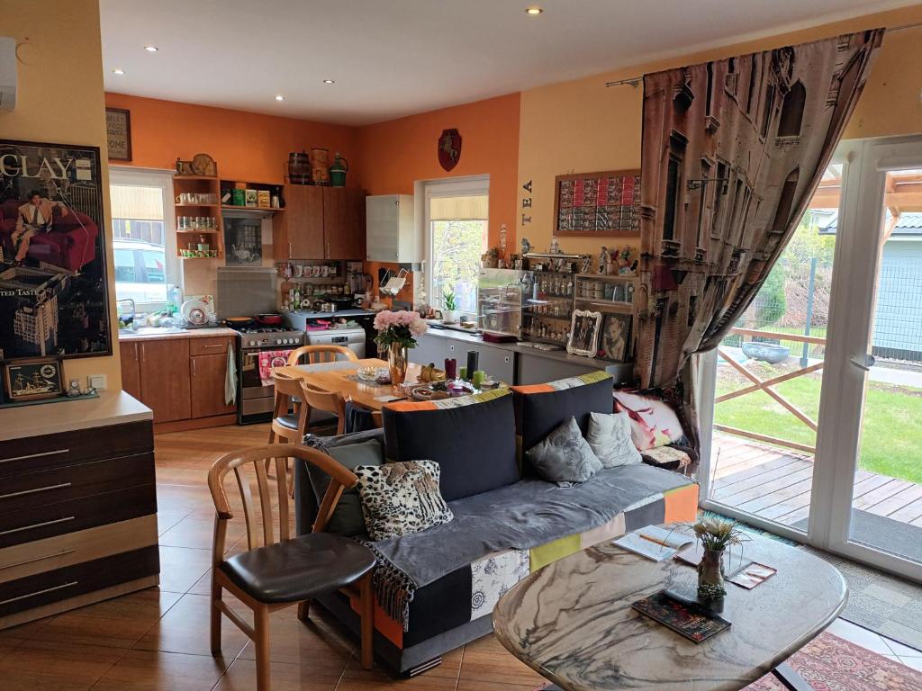 a living room with a couch and a table at Roberto ranch in Palanga