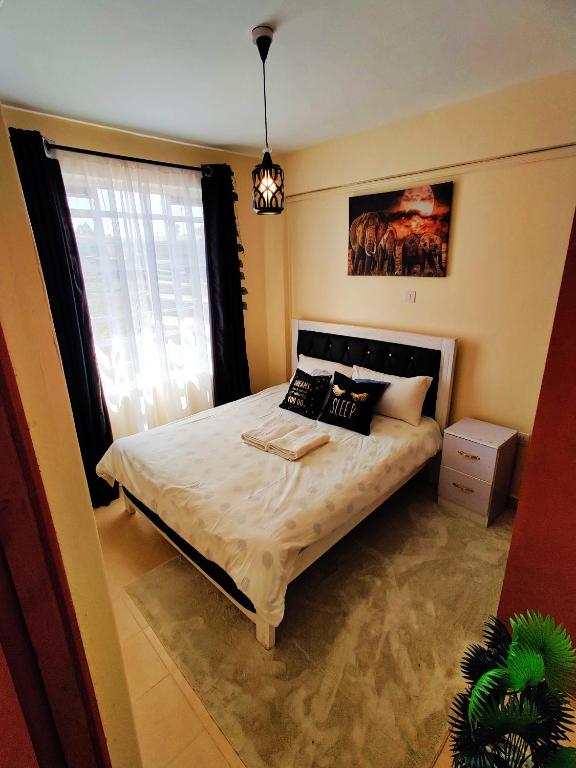 Postel nebo postele na pokoji v ubytování Reigns cozy corner