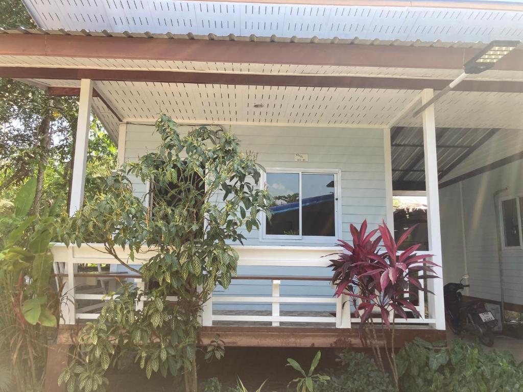a white house with a porch with a window at Sea Salt 2 Cozy Studio with full kitchen and Fast Wifi in Thong Sala