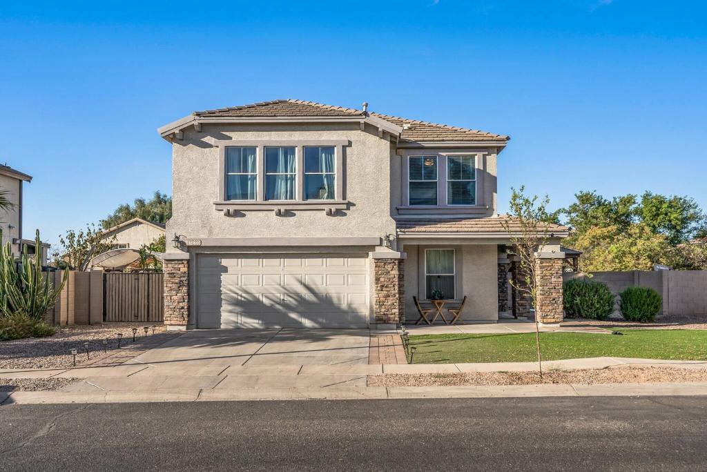 a house with a garage on a street at Spacious Entire Home 4B & 2.5B in Avondale Arizona in Avondale
