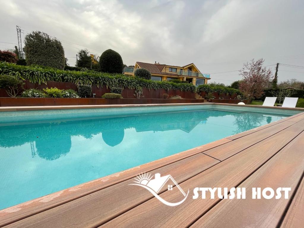 a swimming pool in front of a house at Stylish Host Cantabria- Lujosa villa en Bezana in Santa Cruz de Bezana