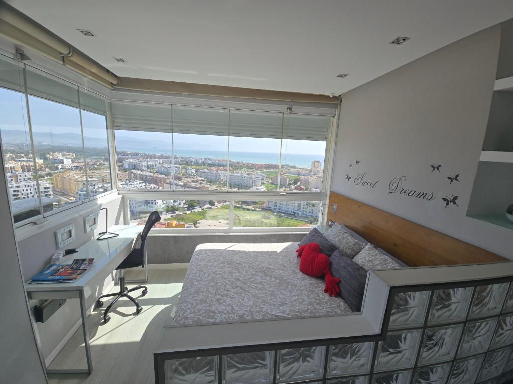 a bedroom with a bed and a desk and a window at Estudio III VISTAS MAR, TREN Y MALAGA in Torremolinos