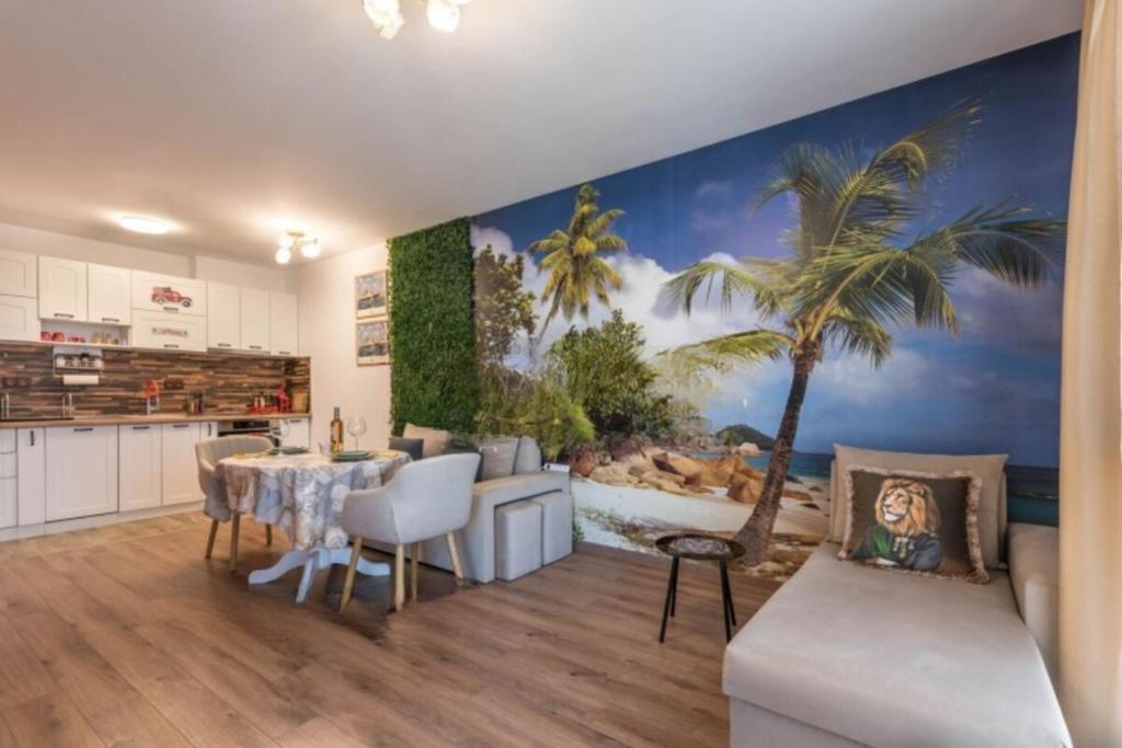 a kitchen and dining room with a palm tree mural at Lili's Azur beach Apartment in Varna City
