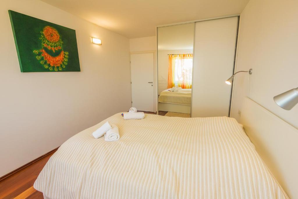 a bedroom with a bed with two towels on it at Apartments Villa Dinka in Opatija