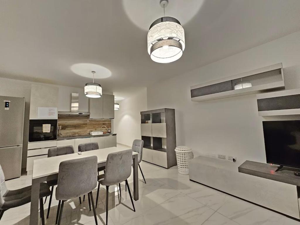 a kitchen with a table and chairs in a room at Central Apartment Sliema John in Sliema