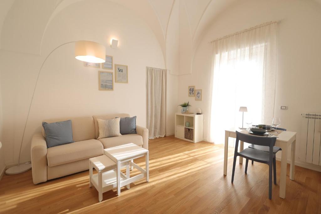 a living room with a couch and a table at "CasaMia" Apartment - Brindisi Historic Center in Brindisi