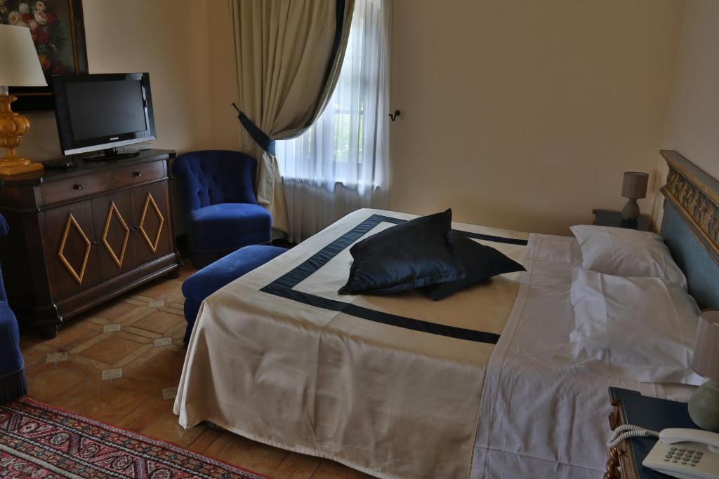 Postel nebo postele na pokoji v ubytování Hotel La Collegiata