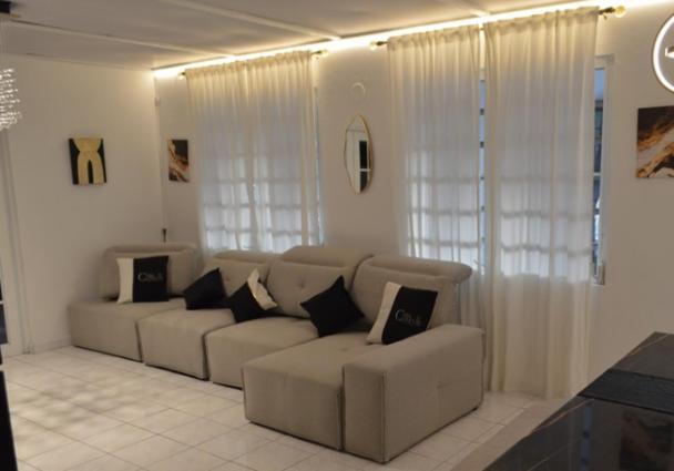a living room with a couch with pillows at Casa Clemente Vacation Rentals in Carolina