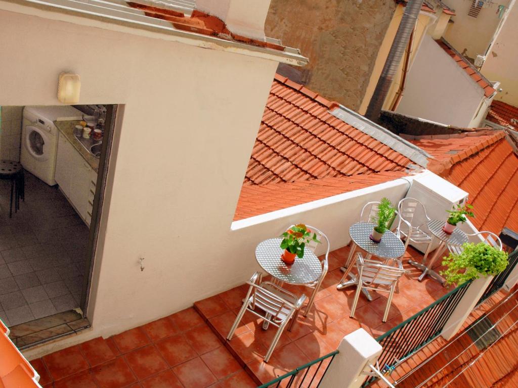 an overhead view of a balcony with tables and chairs at Welcome Guest House in Lisbon