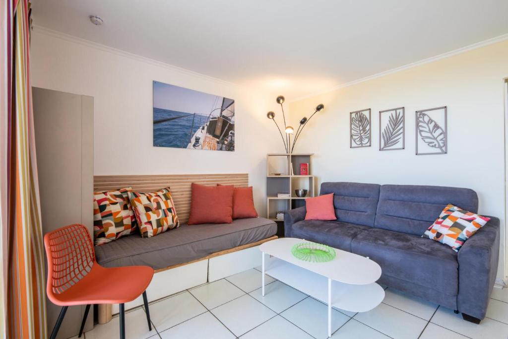 un salon avec un canapé et une table dans l'établissement Résidence le Village de Cap Esterel - maeva Home - Appartement 2 Pièces 5 Personnes - Prestige - super Home MAE-2135, à Saint-Raphaël