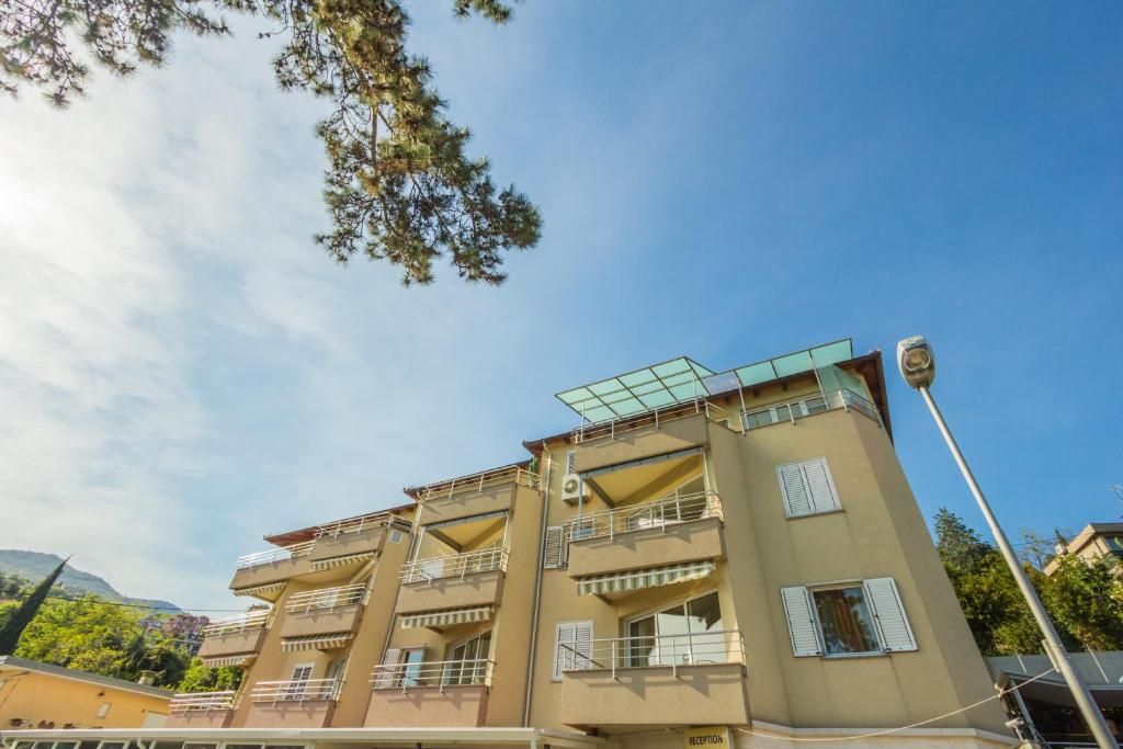 a building with balconies on the side of it at Apartments Villa Dinka in Opatija