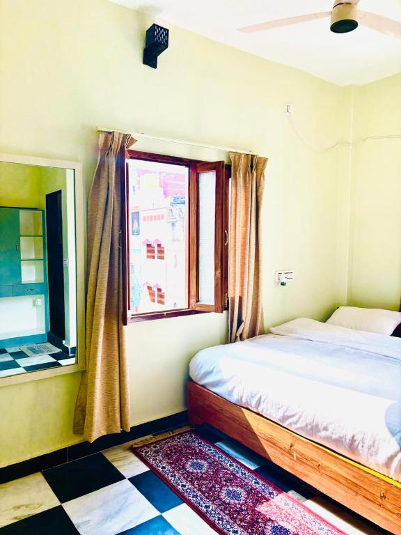 a bedroom with a bed and a window at Narayana's Haveli in Varanasi