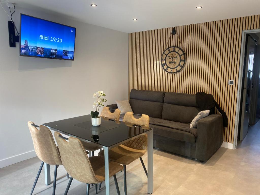 un salon avec une table et un canapé dans l'établissement Villa pinède - Proche naturiste, au Cap d'Agde