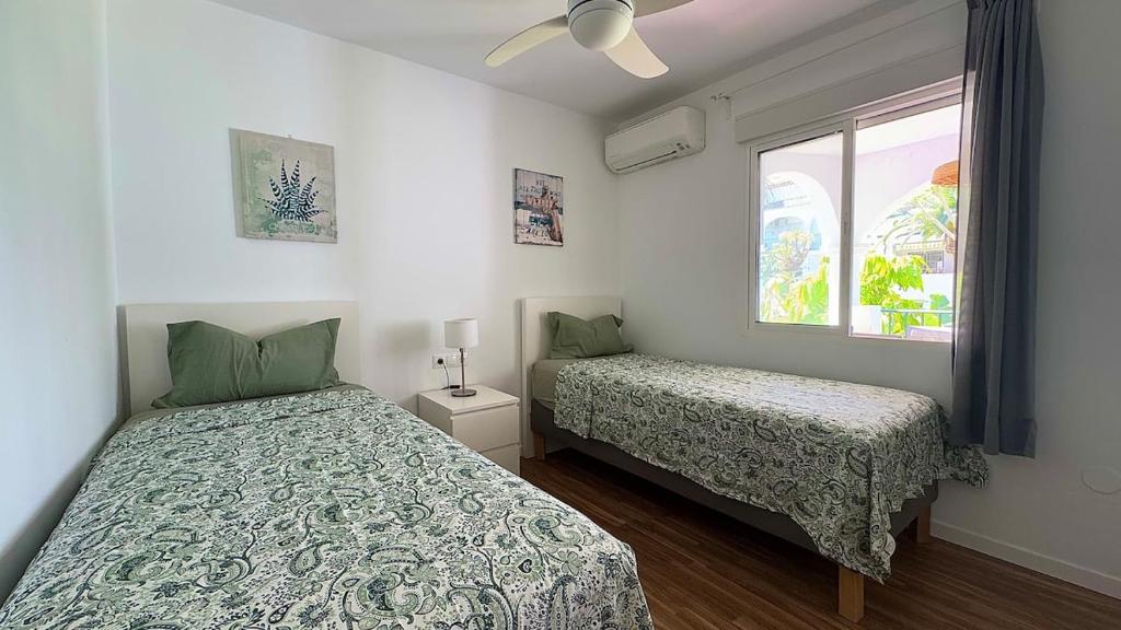 En eller flere senge i et værelse på Benalmádena coastal apartment