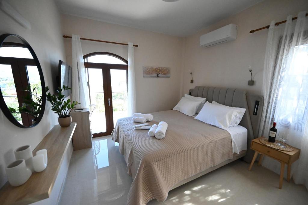 a bedroom with a bed with two towels on it at Unick Seaview Luxury Living in Kalathas