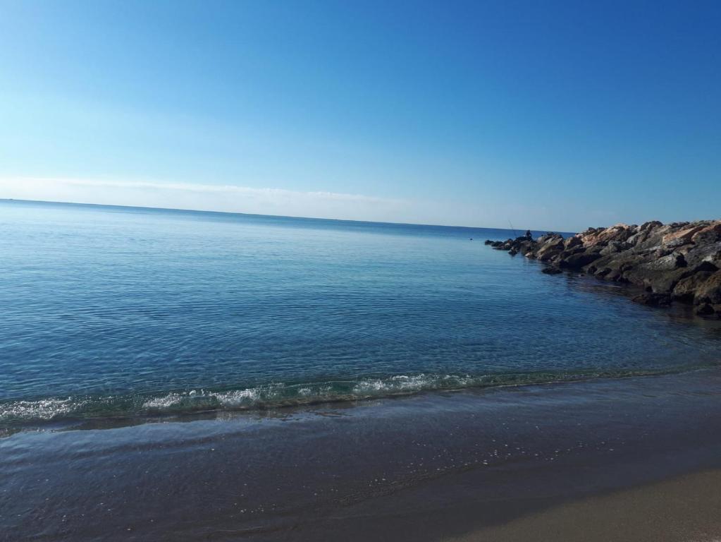 a view of the ocean from a beach with rocks at Apartamento Junto AL MAR Quesada 2 in Almería