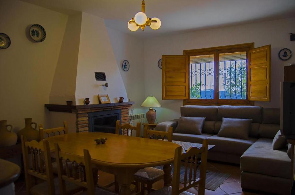 a living room with a table and a couch at Casa Número 3 in Válor
