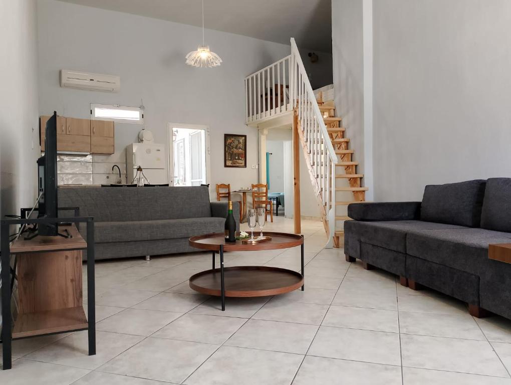 a living room with a couch and a table at Old Cafe Apartment in Skala Kallirachis