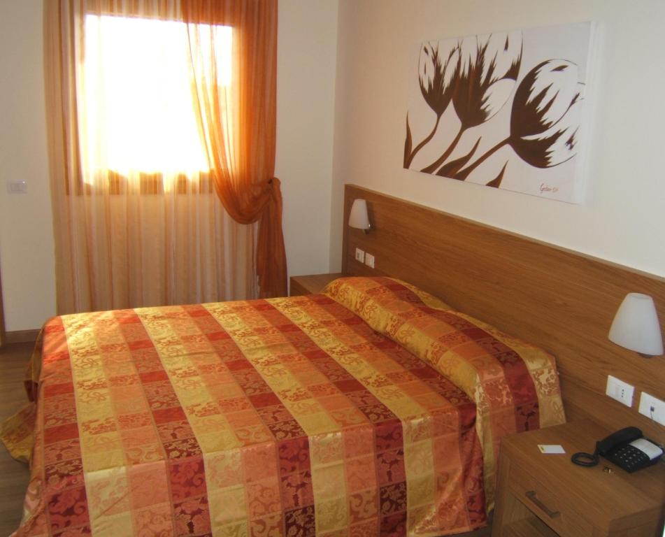 Postel nebo postele na pokoji v ubytování Hotel Calinferno