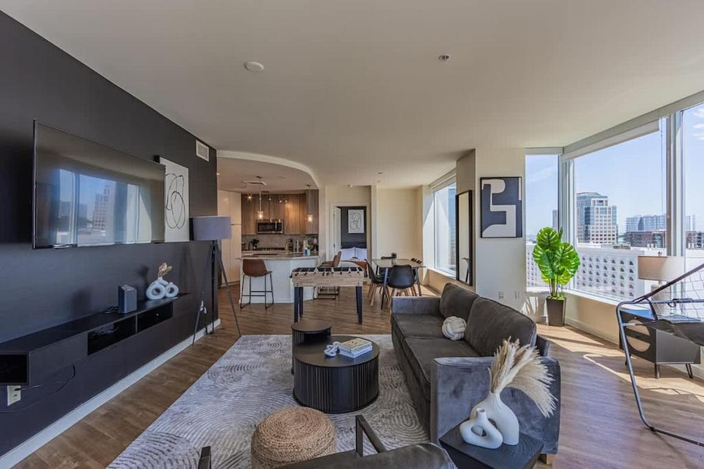 a living room with a couch and a table at Modern HighRise Sanctuary, Gym, Pool, Prking, W-D, Golf in Phoenix