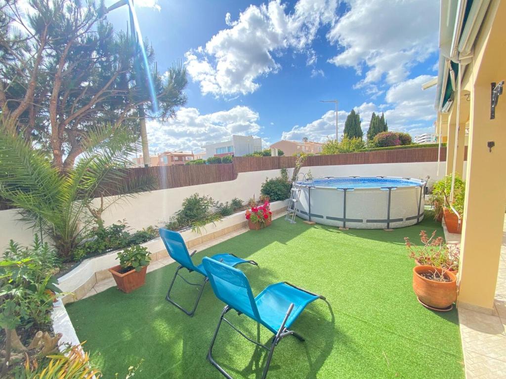 a patio with two chairs and a swimming pool at Porto de Mós Family House in Lagos