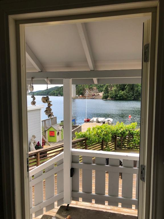 a view of the water from a house balcony at Barnevennlig med strand og hage - Wifi in Søgne