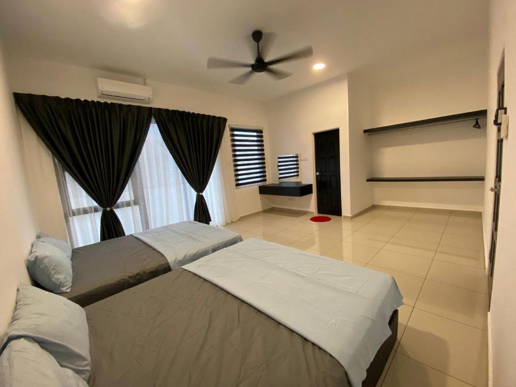 a bedroom with a bed and a ceiling fan at WeStay Homestay 15-1 in Bukit Mertajam
