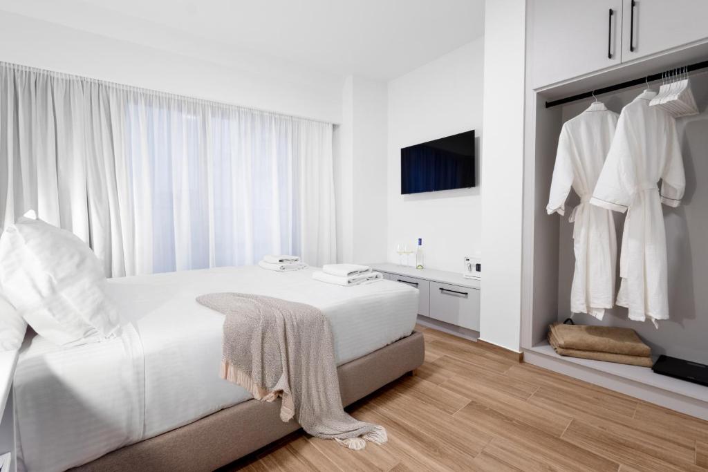 Postel nebo postele na pokoji v ubytování Enea City Suites