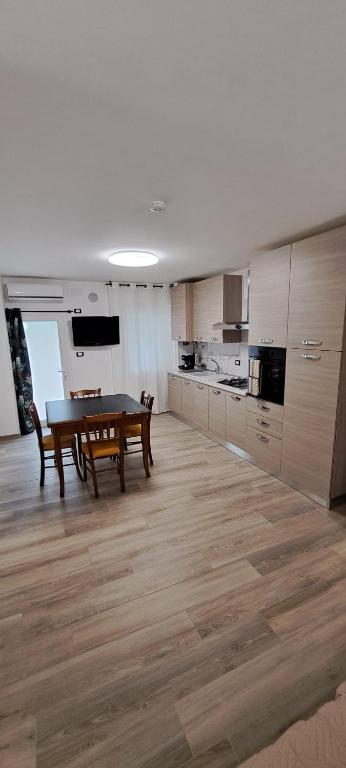 a kitchen with a table and a dining room at Casa Mar in Francavilla al Mare