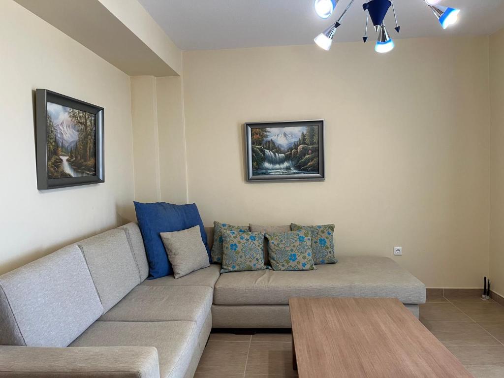 a living room with a couch and a table at Sidis Beach Home Flogita in Flogita