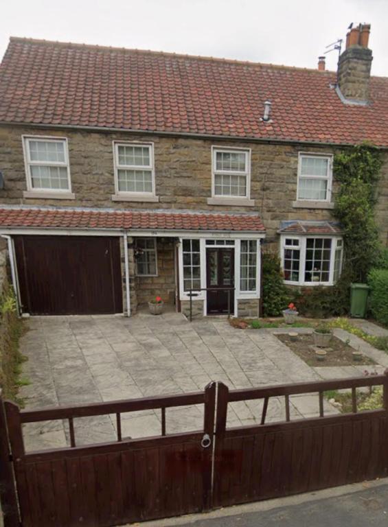 a house with a large patio in front of it at Ryedale House in Sleights