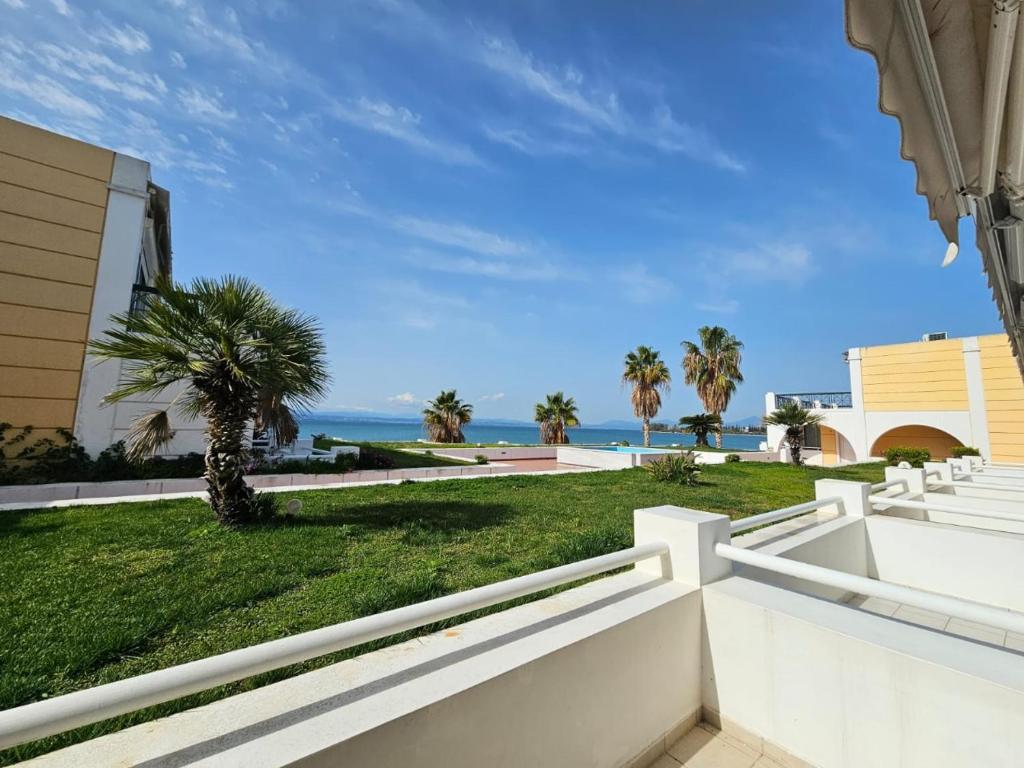 a view of the ocean from the balcony of a house at Sunset on the Beach Apartment in Eretria