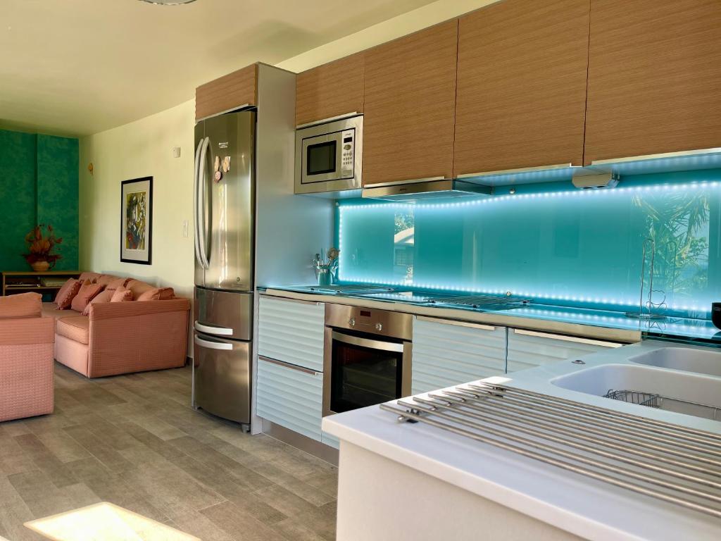 a kitchen with a sink and a refrigerator at Jolie apartment-Panorama view in Porto Rafti