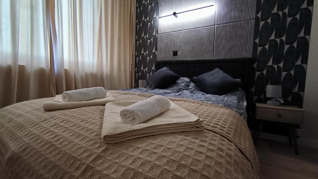a bedroom with a bed with two towels on it at Millenium Park Apartment 2-pokojowy in Gdańsk