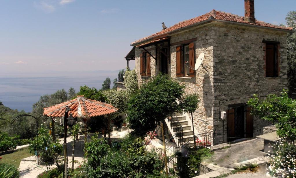 a stone house with a staircase leading up to it at Tsorni Hill Cottage in Lefokastro