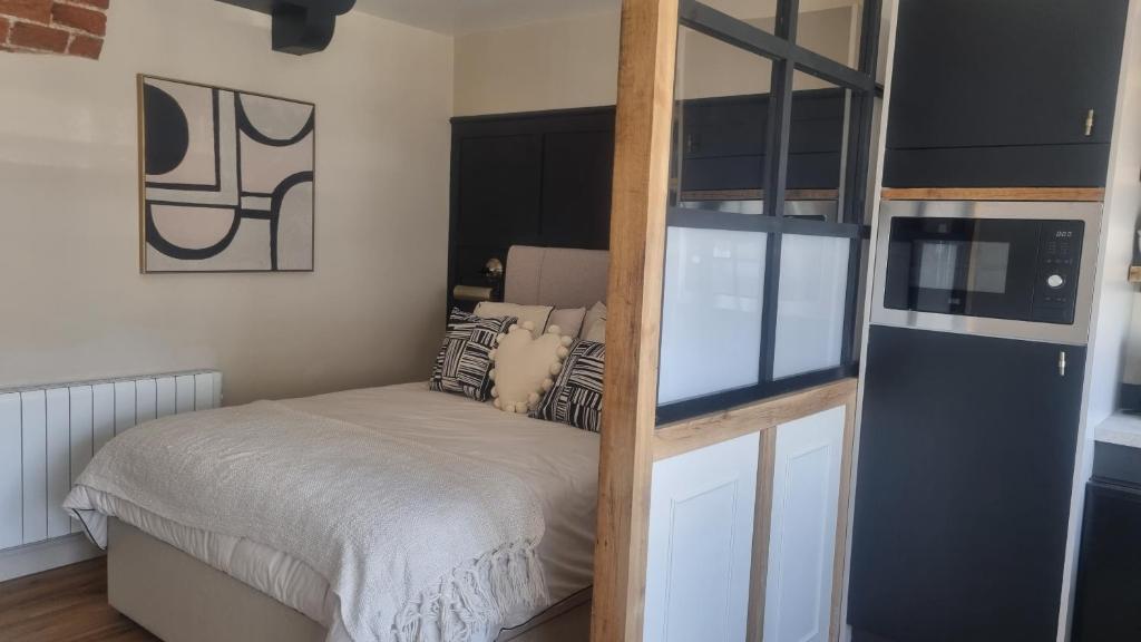 a small bedroom with a bed and a ladder at The Old Shop High Street in Llanidloes