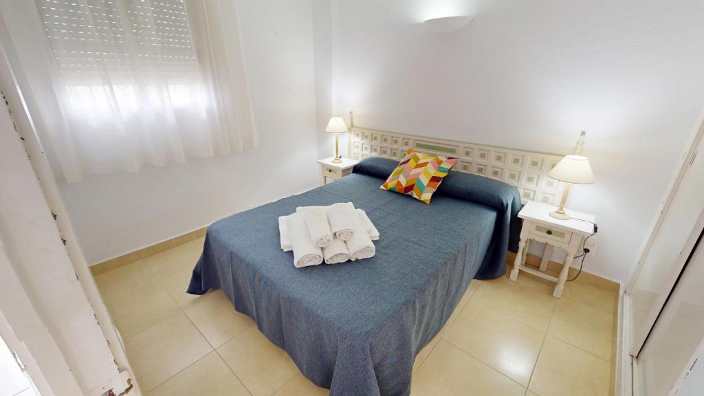 Ένα ή περισσότερα κρεβάτια σε δωμάτιο στο Apartamentos Concorde