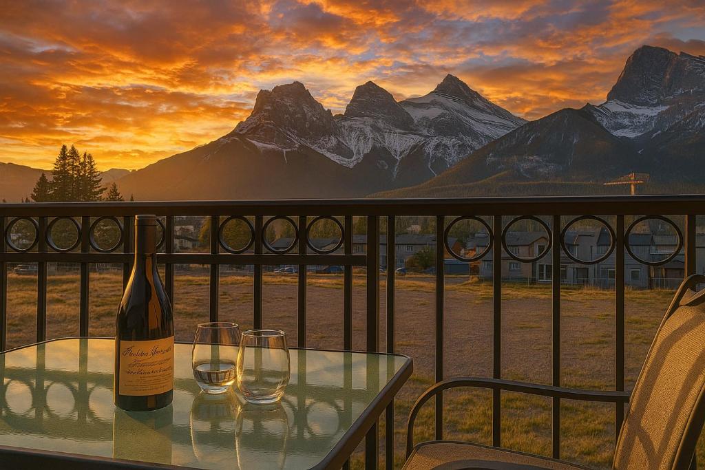 a bottle of wine sitting on a table with two glasses at Luxury 3B Mountain Views- Pool & Hot Tub -Sleeps 10 in Canmore